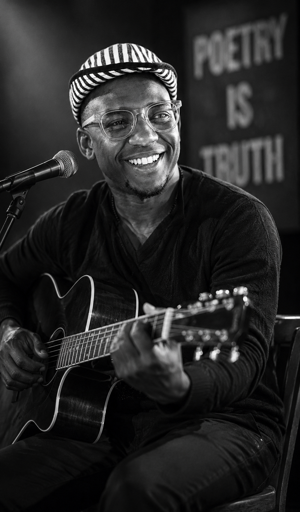 Portrait of Tshepo Matlheketlha holding an acoustic guitar